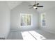 A spacious bedroom with plush carpet, a ceiling fan, and a large window with wooded views at 152 Wet Wood Dr # 10, Fairburn, GA 30213