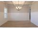Light filled dining room features wainscoting, wood floors and a modern chandelier at 152 Wet Wood Dr # 10, Fairburn, GA 30213