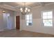 Elegant dining room with wainscoting, a modern chandelier, hardwood floors, and abundant natural light at 152 Wet Wood Dr # 10, Fairburn, GA 30213