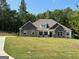 Craftsman style home boasts stone accents, inviting front porch and expansive front lawn at 152 Wet Wood Dr # 10, Fairburn, GA 30213