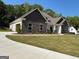Beautiful stone and siding home with a manicured lawn and attached two car garage at 152 Wet Wood Dr # 10, Fairburn, GA 30213