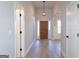 Welcoming foyer featuring a wooden front door, stylish light fixture, and hardwood floors at 152 Wet Wood Dr # 10, Fairburn, GA 30213