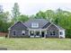 Charming single-Gathering home with stone accents, complemented by well-manicured lawn and lush greenery at 152 Wet Wood Dr # 10, Fairburn, GA 30213