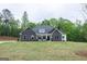 Beautiful home with a stone facade, complemented by a lush green lawn and framed by mature trees at 152 Wet Wood Dr # 10, Fairburn, GA 30213