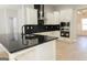 Stylish kitchen featuring white cabinets, black countertops, and stainless steel appliances at 152 Wet Wood Dr # 10, Fairburn, GA 30213