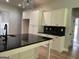 Kitchen island with dark countertop and white cabinetry in a modern home interior at 152 Wet Wood Dr # 10, Fairburn, GA 30213