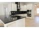 Well-designed kitchen with stainless steel appliances, white cabinets, and a sleek black countertop with waterfall edge at 152 Wet Wood Dr # 10, Fairburn, GA 30213