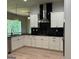 Bright, modern kitchen with stainless steel range hood and black backsplash with herringbone pattern at 152 Wet Wood Dr # 10, Fairburn, GA 30213