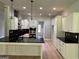 Modern kitchen featuring white cabinets, black countertops and backsplash, and stainless steel appliances at 152 Wet Wood Dr # 10, Fairburn, GA 30213
