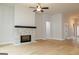 Spacious living room featuring a stone fireplace, hardwood floors, and a ceiling fan at 152 Wet Wood Dr # 10, Fairburn, GA 30213