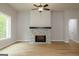 Spacious living room featuring a ceiling fan and beautiful stone fireplace as focal points at 152 Wet Wood Dr # 10, Fairburn, GA 30213