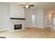 Open living room with a stone fireplace and a ceiling fan, bathed in natural light at 152 Wet Wood Dr # 10, Fairburn, GA 30213