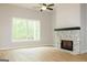 Living room with a stone fireplace, hardwood floors, and a ceiling fan at 152 Wet Wood Dr # 10, Fairburn, GA 30213