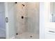 Beautiful walk-in shower featuring neutral tile, a glass enclosure, and sleek black fixtures at 152 Wet Wood Dr # 10, Fairburn, GA 30213
