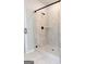 Modern walk-in shower featuring neutral tile, a glass enclosure, and sleek black fixtures at 152 Wet Wood Dr # 10, Fairburn, GA 30213