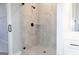 Walk-in shower is tiled in gray and features a shelf and black hardware at 152 Wet Wood Dr # 10, Fairburn, GA 30213