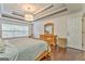 Bright main bedroom with tray ceilings, hardwood floors, and white walls at 408 Gray Fox Dr, Canton, GA 30114