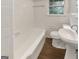 Clean bathroom with white tile, a window, and a classic design with essential fixtures at 828 Pinevalley Dr, Forest Park, GA 30297