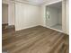 Cozy bedroom showcasing wood laminate flooring and a connected area through a doorway at 828 Pinevalley Dr, Forest Park, GA 30297