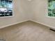 Sunny bedroom with carpet, white trim, and dual windows offering abundant natural light at 828 Pinevalley Dr, Forest Park, GA 30297