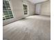 Inviting bedroom with natural light streaming in through large windows and plush carpet at 828 Pinevalley Dr, Forest Park, GA 30297