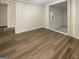 Bedroom showcasing wood-look flooring, white paneled walls, and an attached room at 828 Pinevalley Dr, Forest Park, GA 30297