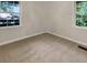 Bright bedroom featuring carpeted floors, neutral walls, and abundant natural light from the windows at 828 Pinevalley Dr, Forest Park, GA 30297