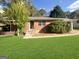 Charming brick home with a well-manicured lawn and inviting front entrance with steps at 828 Pinevalley Dr, Forest Park, GA 30297