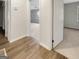Hallway with wood flooring leading to carpeted room with open doorway and white trim at 828 Pinevalley Dr, Forest Park, GA 30297