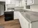 Functional kitchen features white cabinetry, black appliances, and laminate countertops at 828 Pinevalley Dr, Forest Park, GA 30297