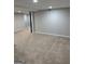 Large, carpeted basement with drop ceilings, recessed lighting, and neutral color palette at 7193 Tara Dr, Villa Rica, GA 30180
