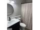 Modern bathroom featuring white vanity, updated fixtures, and shower with curtain at 7193 Tara Dr, Villa Rica, GA 30180