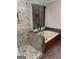 Bright bathroom features a stone shower and a large soaking tub with wood-look cabinets at 7193 Tara Dr, Villa Rica, GA 30180