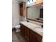 Bathroom features double sinks with granite counters, wood cabinets, and a large mirror at 7193 Tara Dr, Villa Rica, GA 30180