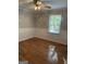 Bedroom with a ceiling fan, a large window with blinds, and hardwood floors at 7193 Tara Dr, Villa Rica, GA 30180