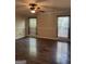 Bedroom featuring hardwood floors, neutral paint, and natural light from two windows at 7193 Tara Dr, Villa Rica, GA 30180
