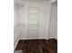 Walk-in closet with installed adjustable white wire shelving and hardwood flooring at 7193 Tara Dr, Villa Rica, GA 30180