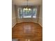 Spacious dining area boasts natural light from a large bay window and gleaming wood floors at 7193 Tara Dr, Villa Rica, GA 30180
