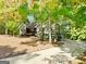 Charming gray home featuring a well-manicured front yard, natural landscaping, and a long driveway at 7193 Tara Dr, Villa Rica, GA 30180