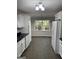Bright kitchen with white cabinets and views of the backyard at 7193 Tara Dr, Villa Rica, GA 30180