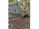 Rear exterior with a new wooden deck overlooking the wooded backyard at 7193 Tara Dr, Villa Rica, GA 30180