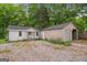 View of backyard featuring the house and a detached garage at 734 W College St, Bowdon, GA 30108