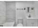 Neutral bathroom features tiled walls and floors and updated vanity at 734 W College St, Bowdon, GA 30108
