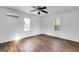 Bright bedroom with updated floors, ceiling fan, and large windows offering natural light at 734 W College St, Bowdon, GA 30108