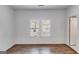 White bedroom features hardwood floors and bright window at 734 W College St, Bowdon, GA 30108