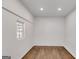 Bright bedroom with hardwood floors, white walls, natural light, and beadboard ceiling at 734 W College St, Bowdon, GA 30108