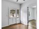 Bright entryway features a paneled front door, hardwood floors, and white walls creating an inviting space at 734 W College St, Bowdon, GA 30108