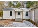 Cozy white home featuring a covered entry, offering a warm and inviting welcome at 734 W College St, Bowdon, GA 30108