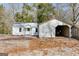Charming home featuring an attached single-car garage and carport, set amidst a natural landscape at 734 W College St, Bowdon, GA 30108