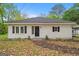 Charming one-story home featuring a black front door and tidy landscaping at 734 W College St, Bowdon, GA 30108